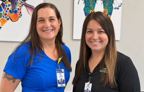 Two smiling Saco River Medical Group staff members wearing ID badges.